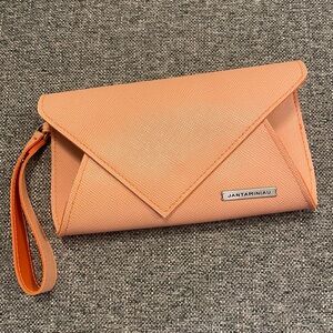 Jantaminiau for KLM airlines orange business class travel accessory clutch bag